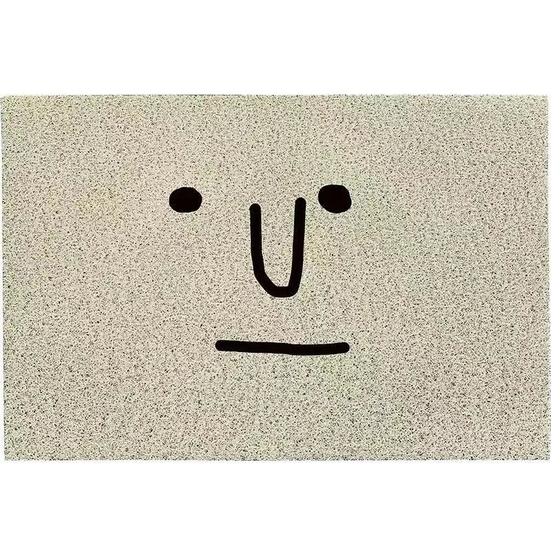 Square PVC floor mat with a geometric cartoon face pattern in Mr. Big Nose colour.