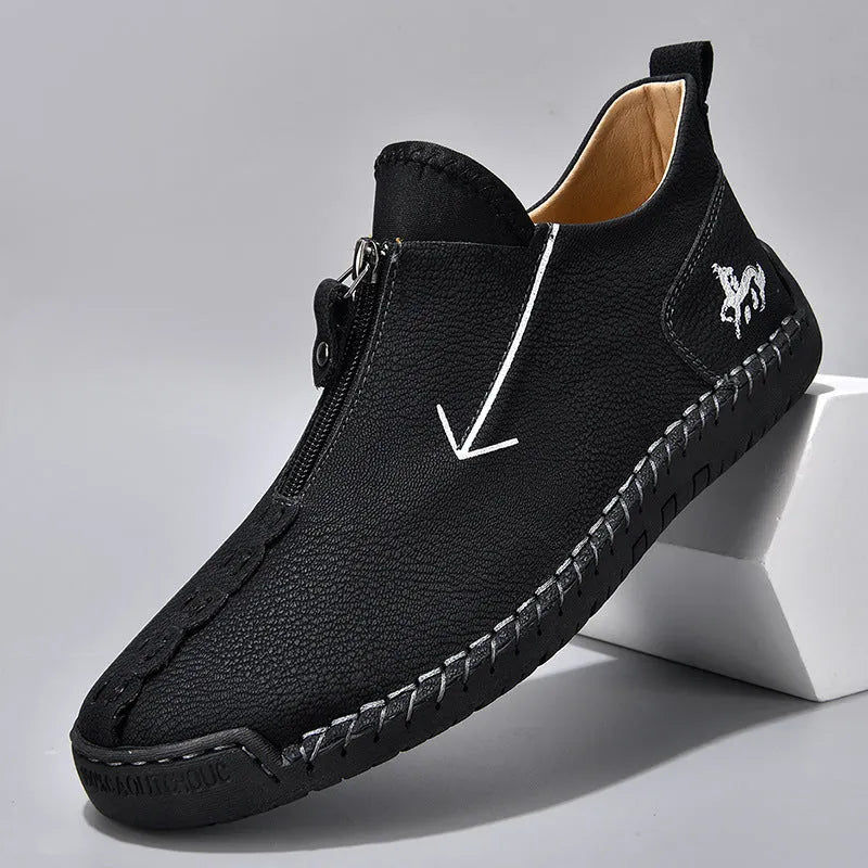 Men's black martin boot with front zipper and round toe on a rubber sole.