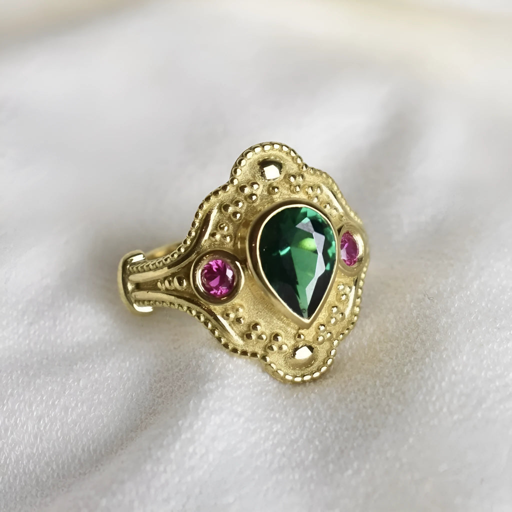 Geometric golden women's fashion ring on a grey background, showing its electroplated alloy construction.