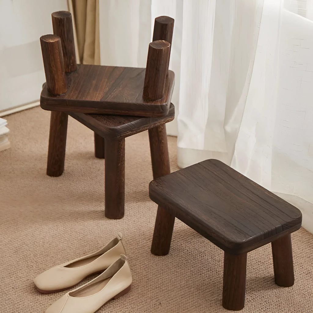 Solid wood shoe changing stool with distressed finish and bracket structure in a living room setting