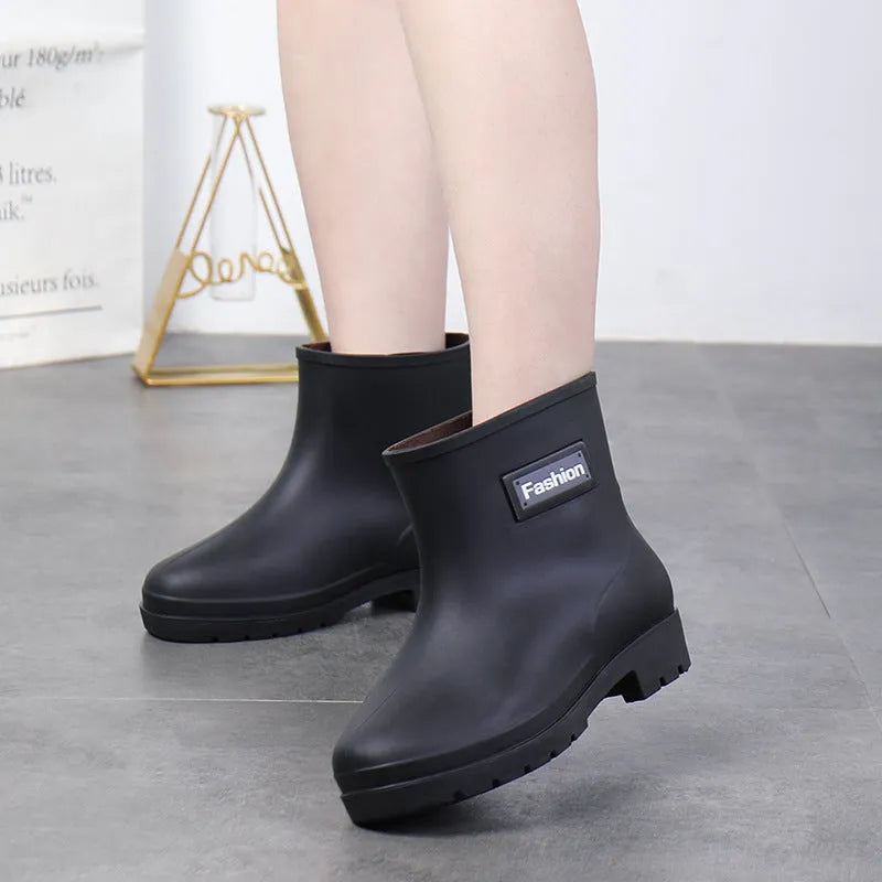 Women's mid-calf PVC rain boots in black with low heel for waterproof work footwear