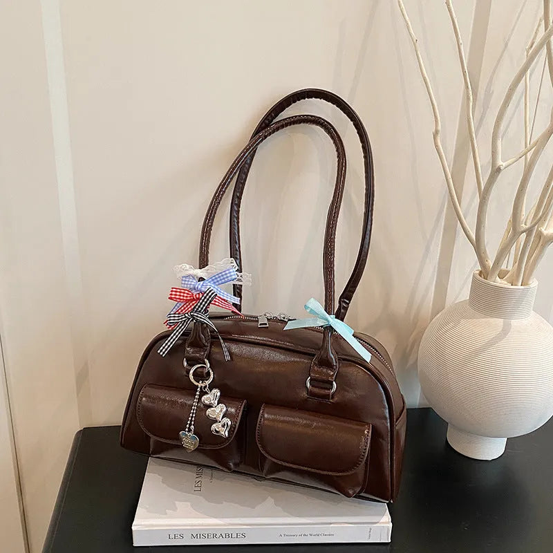 Retro brown PU women's pillow handbag with a flap closure and double shoulder strap.