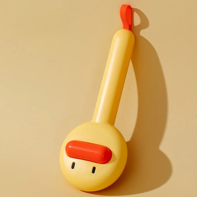 Small yellow duck-shaped pet grooming comb with open sections and needle bristles