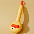 Small yellow duck-shaped pet grooming comb with open sections and needle bristles