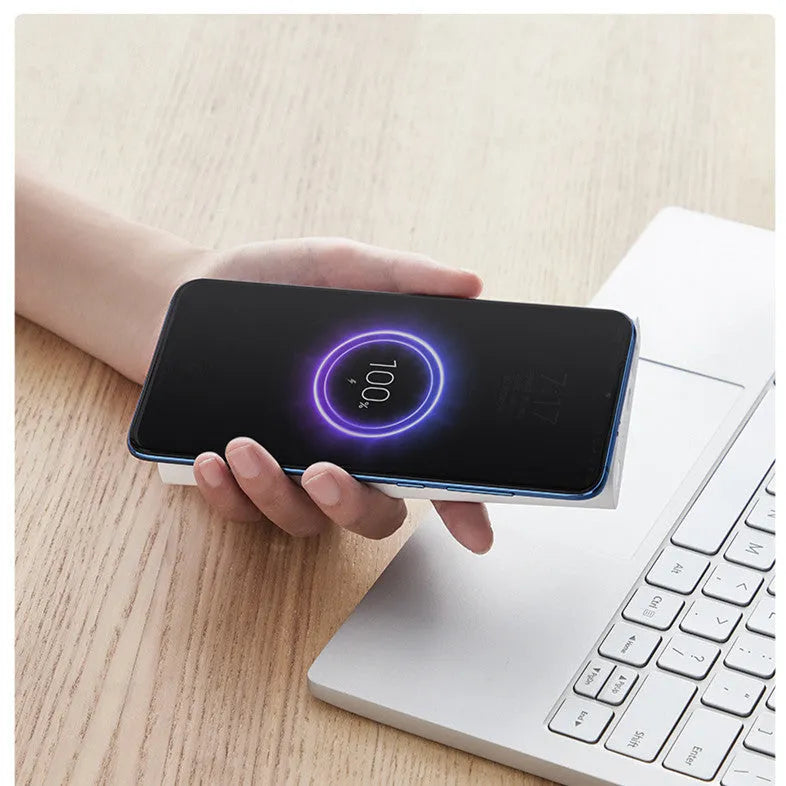 White or black 10000mAh polymer lithium ion power bank with fast charging and wireless output.