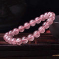Natural strawberry quartz bracelet for women with polished beads in 6mm, 8mm, or 10mm size options.