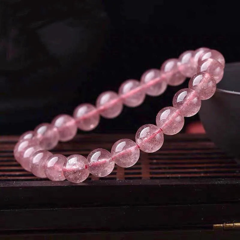 Natural strawberry quartz bracelet for women with polished beads in 6mm, 8mm, or 10mm size options.