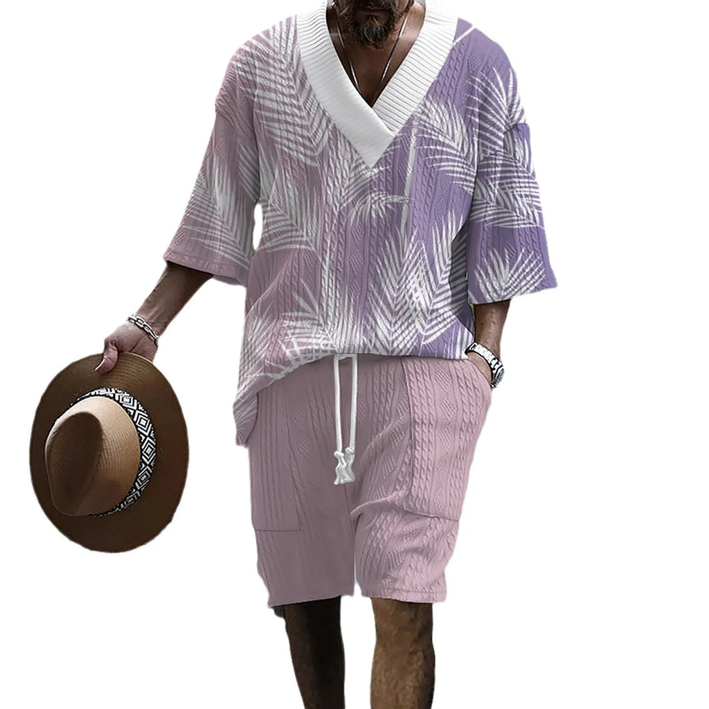 Man wearing a printed drop-shoulder short-sleeved knitted top with matching shorts in a blue colour.