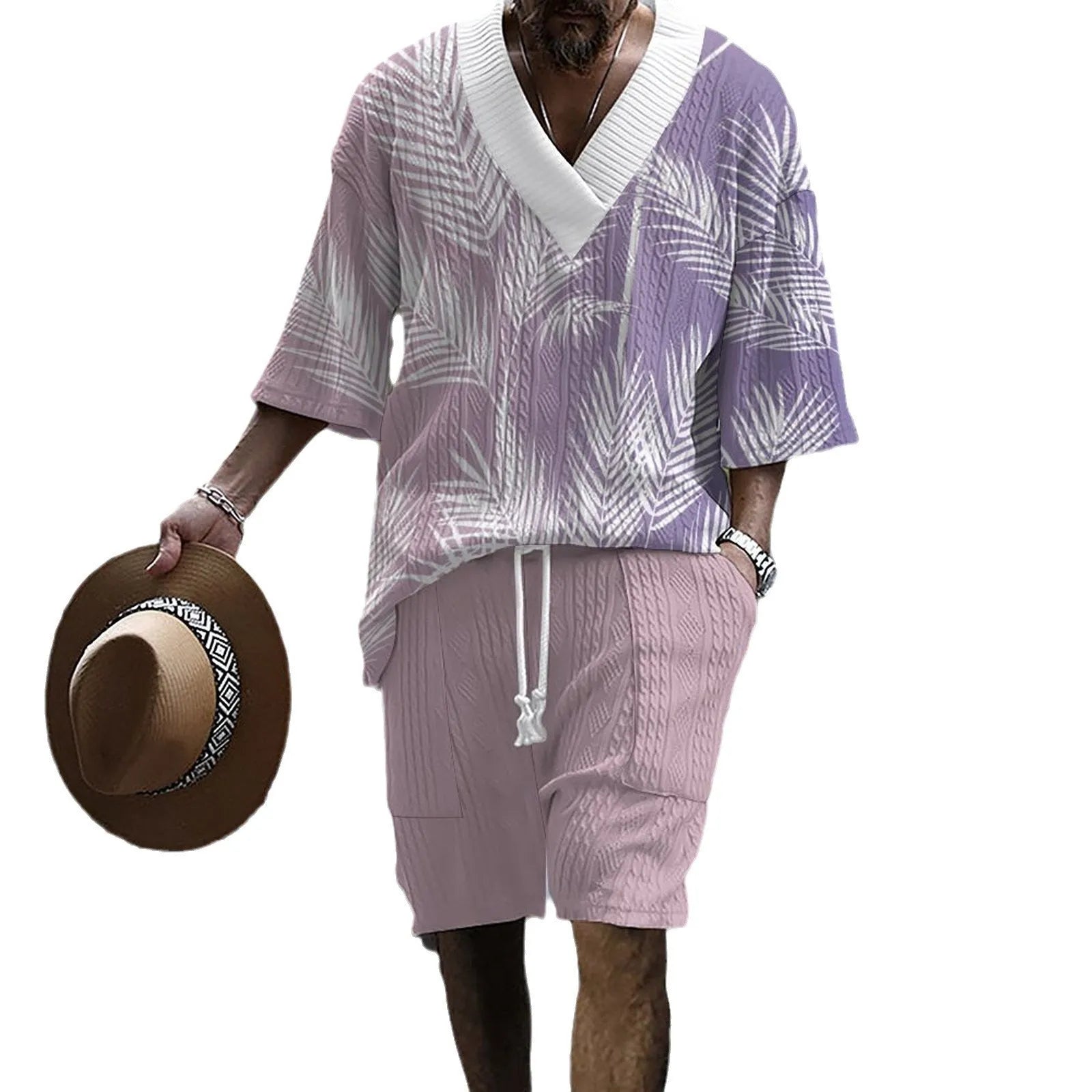 Man wearing a printed drop-shoulder short-sleeved knitted top with matching shorts in a blue colour.