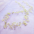 Bridal pearl hair band in silver, gold, or rose gold on a white background, showing wired construction.
