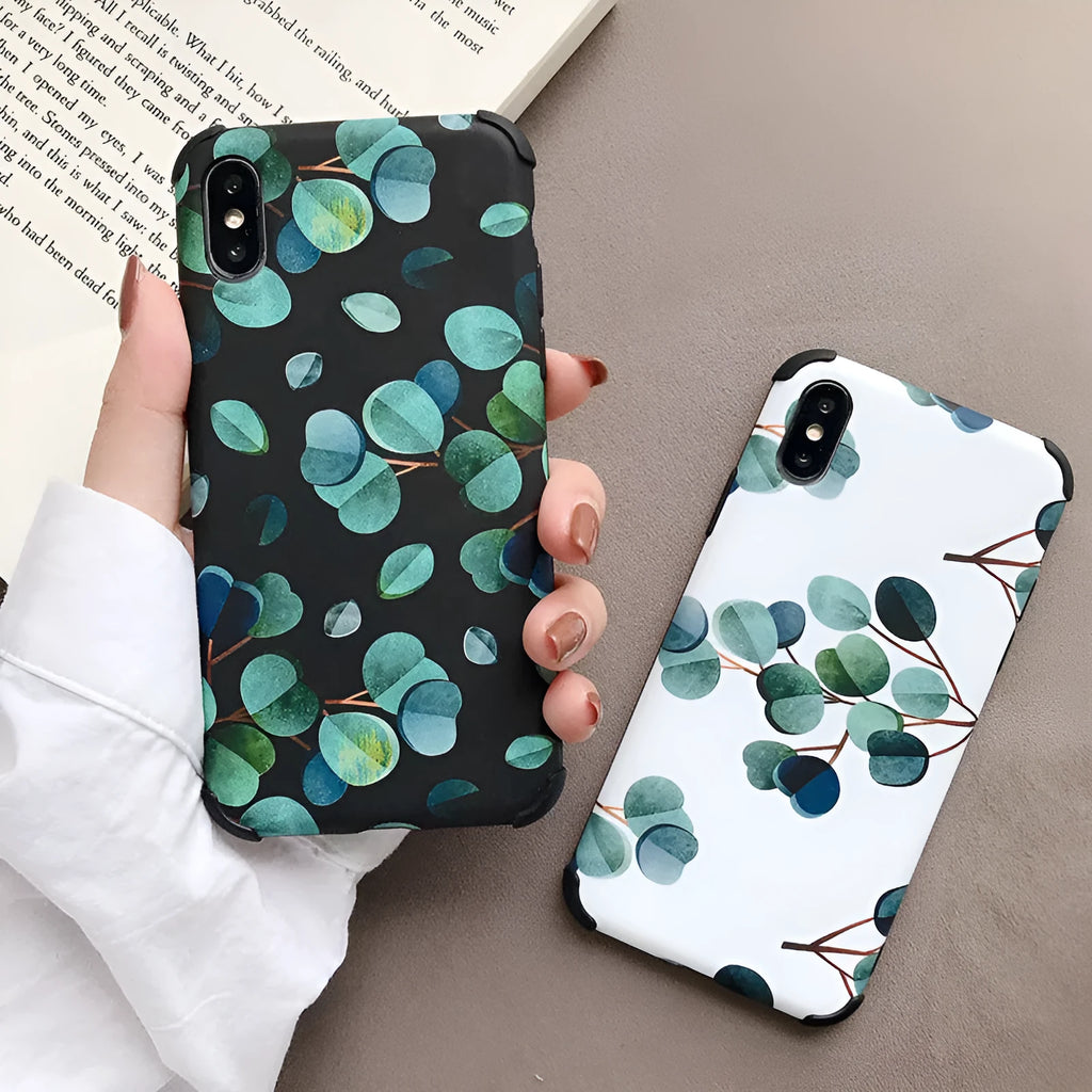 Black silicone iPhone case featuring a decorative leaf print design on the back.