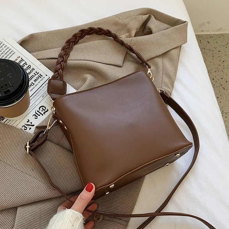 Retro woven PU leather crossbody bucket bag in khaki colour showing bucket shape and shoulder strap