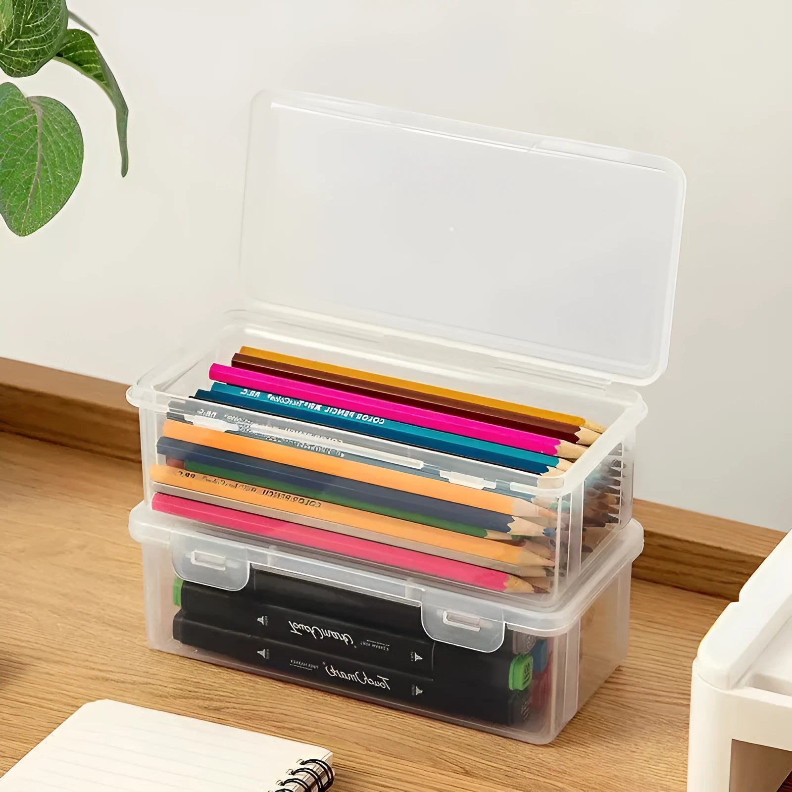 Transparent plastic pencil storage box with large capacity for crayons and colouring pencils.