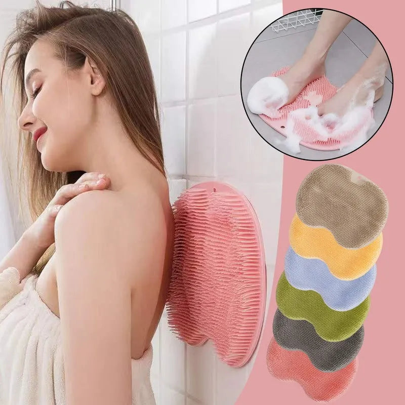 Orange non-slip silicone bath massage mat with suction cups on a bathroom floor.