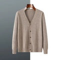 Man wearing a loose beige Andy Velvet V-neck cardigan coat with long sleeves.