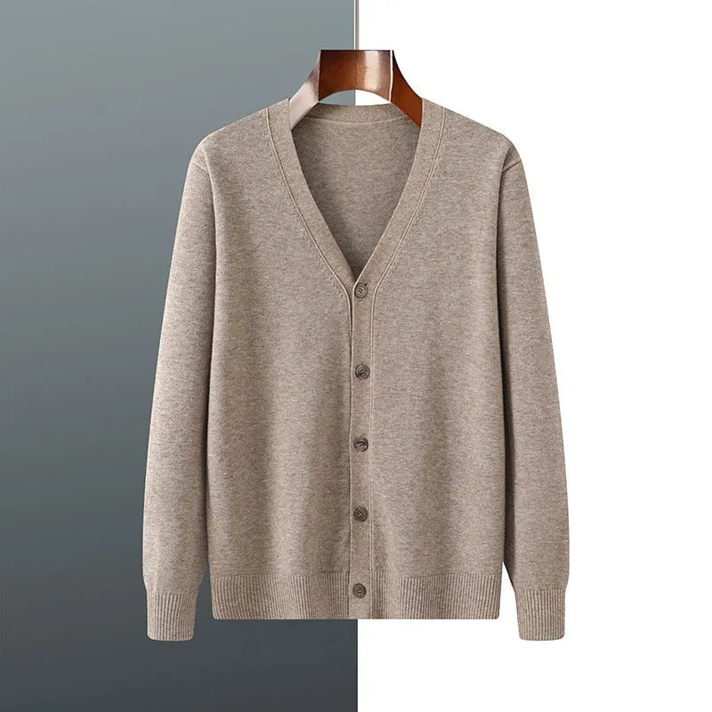 Man wearing a loose beige Andy Velvet V-neck cardigan coat with long sleeves.
