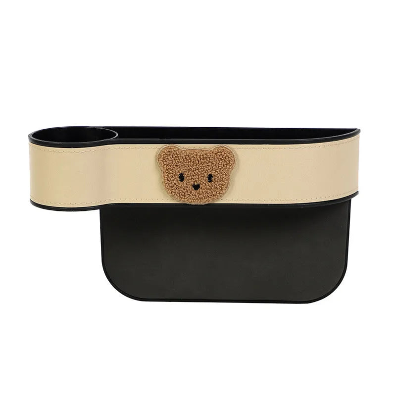 Leather car seat gap storage box with a cartoon bear design hanging next to a car seat.