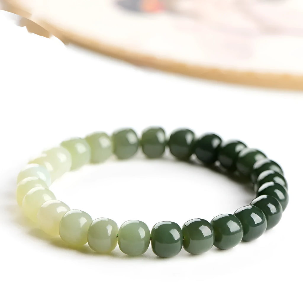 Natural Hetian jade bracelet with water gradient colouring showing polished stones in casual unisex design