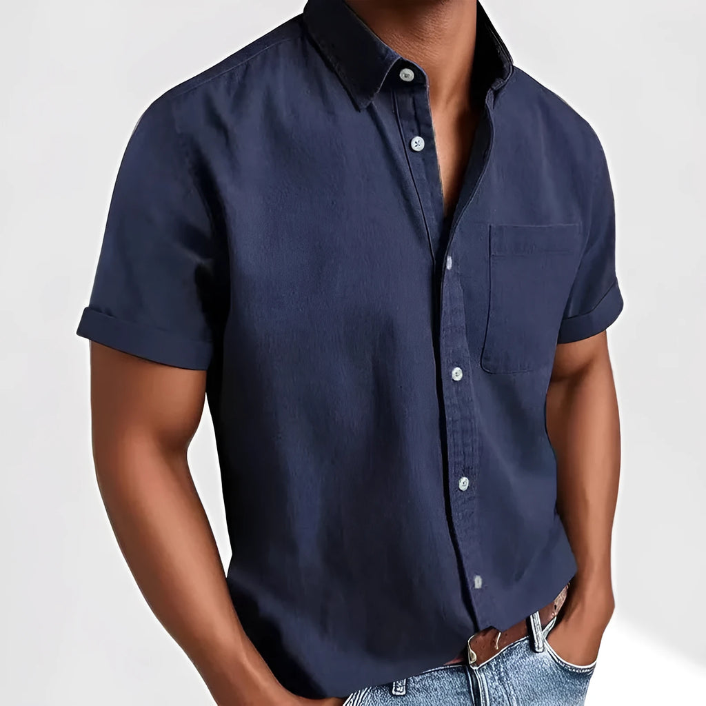 Man wearing a loose grey short sleeve single-breasted cardigan-style shirt.