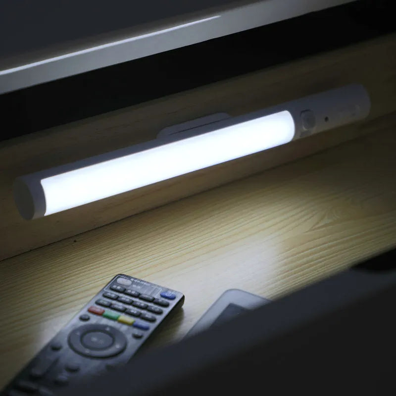 Slim white human induction cabinet wall light with magnetic back for installation on metal surfaces