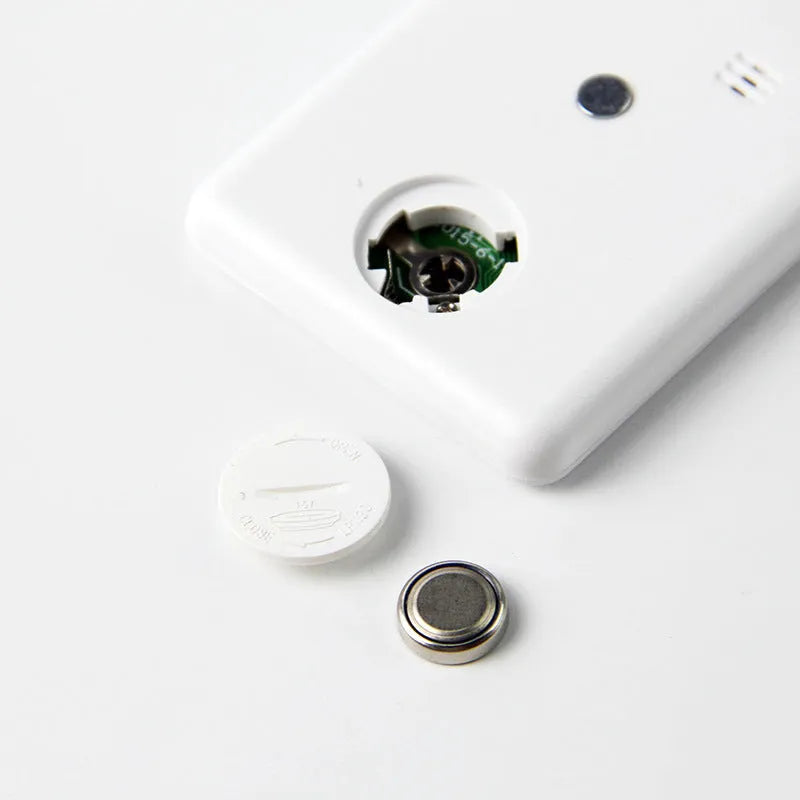 Black and white kitchen timer with magnet back for refrigerator mounting.