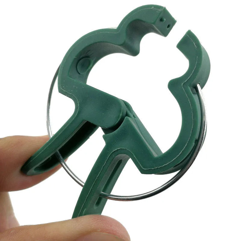 Green plastic plant fixing clips, 10 large and 10 small, for securing climbing plants like tomatoes and cucumbers.