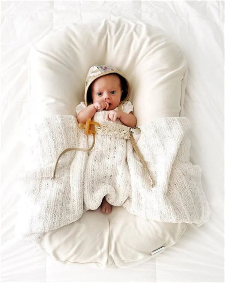 Beige portable cotton baby nest bed crib for newborns, measuring 75 cm by 45 cm.