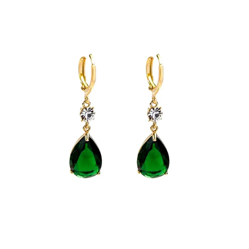 Emerald green geometric teardrop alloy earrings dangling from a model's ear.