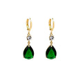 Emerald green geometric teardrop alloy earrings dangling from a model's ear.