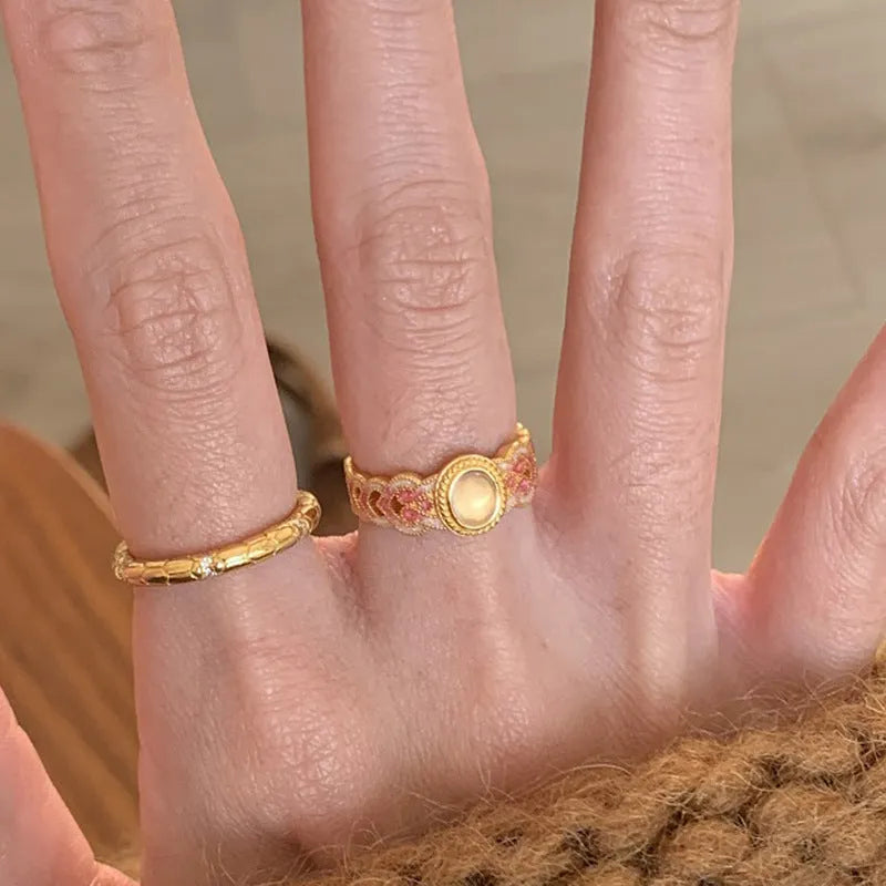 Geometric open mouth women's ring with pink crystal enamel on gold-plated copper.