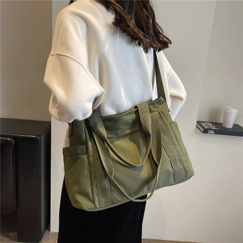 Large solid colour polyester canvas shoulder tote bag for women with internal mobile phone pocket.