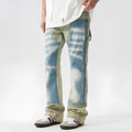 Men's yellow and blue patchwork jeans with a retro splash-ink damaged design on the legs.