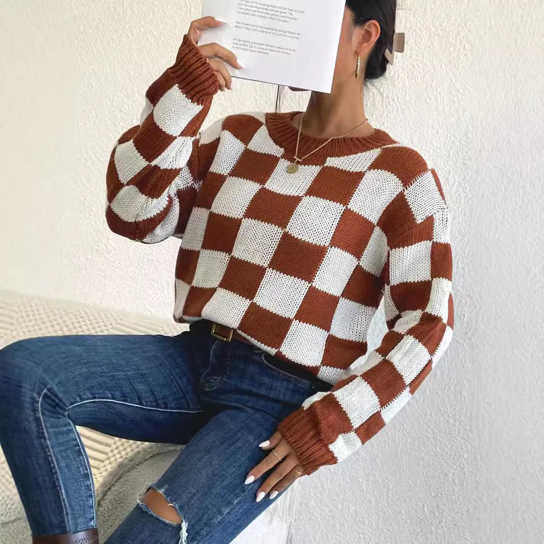 Dark brown loose plaid pullover sweater with long sleeves and a round neck.