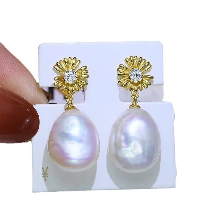 S925 sterling silver baroque flower design earrings and ring holder on a table.