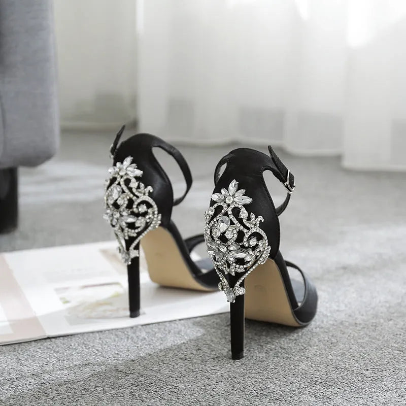 Black suede women's high heels with rhinestone detail and a fish mouth toe.