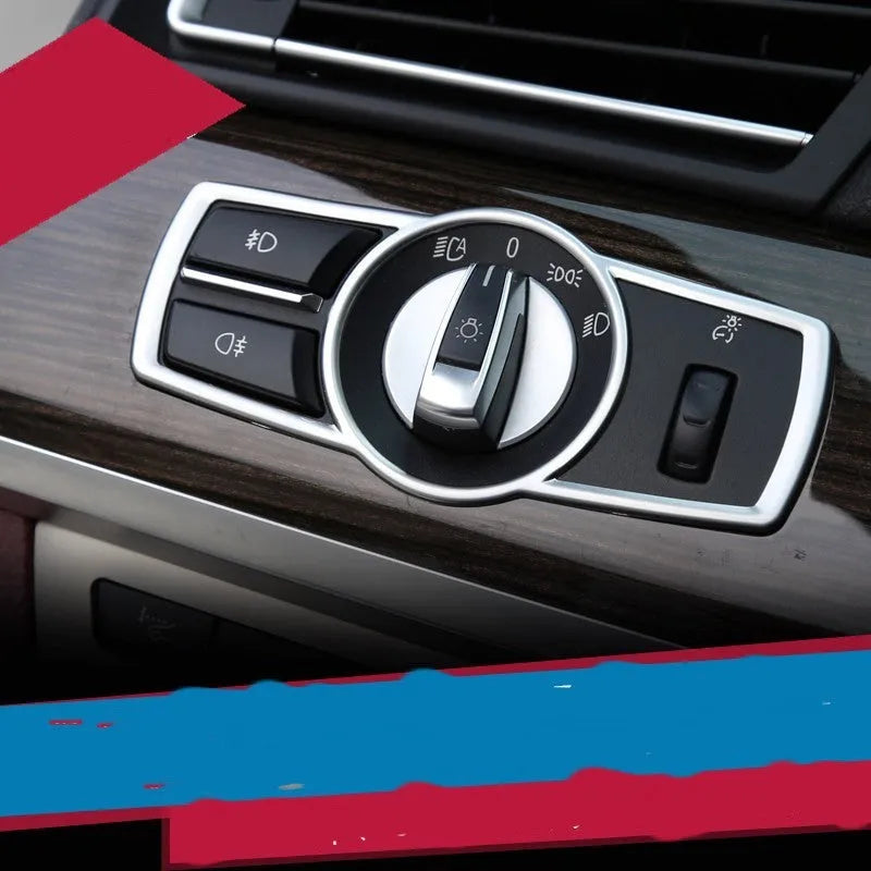Silver ABS plastic decorative strip sticker for BMW headlight switch frame interior modification.