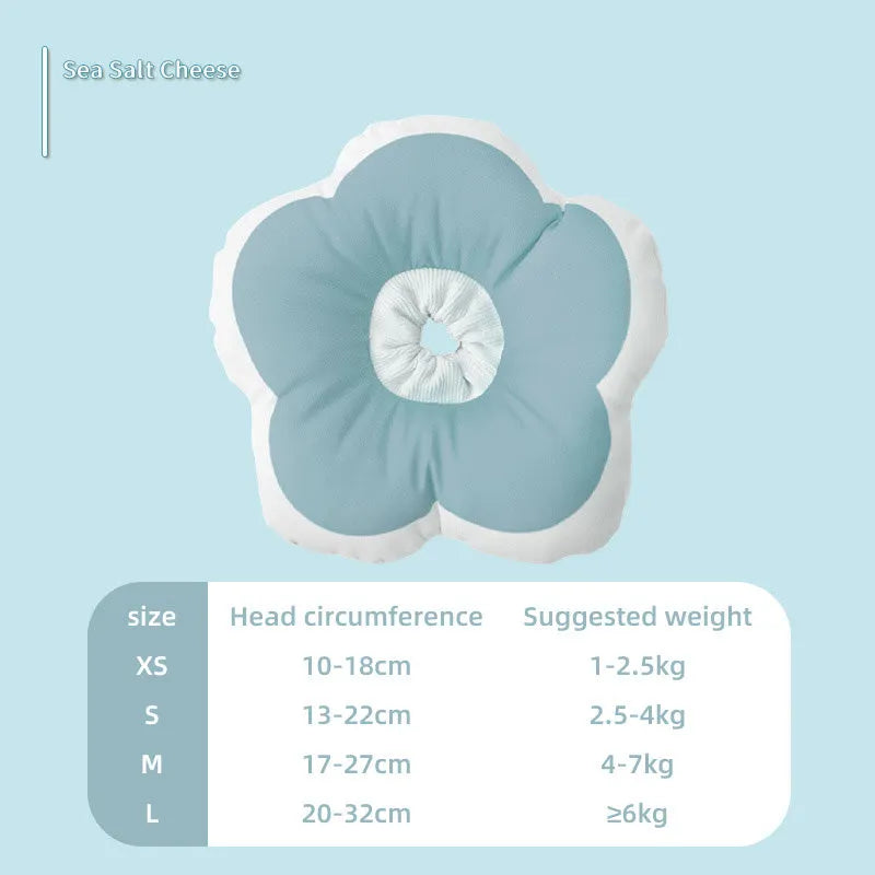 Soft cotton cat recovery collar in light blue with adjustable strap, shown on a table.