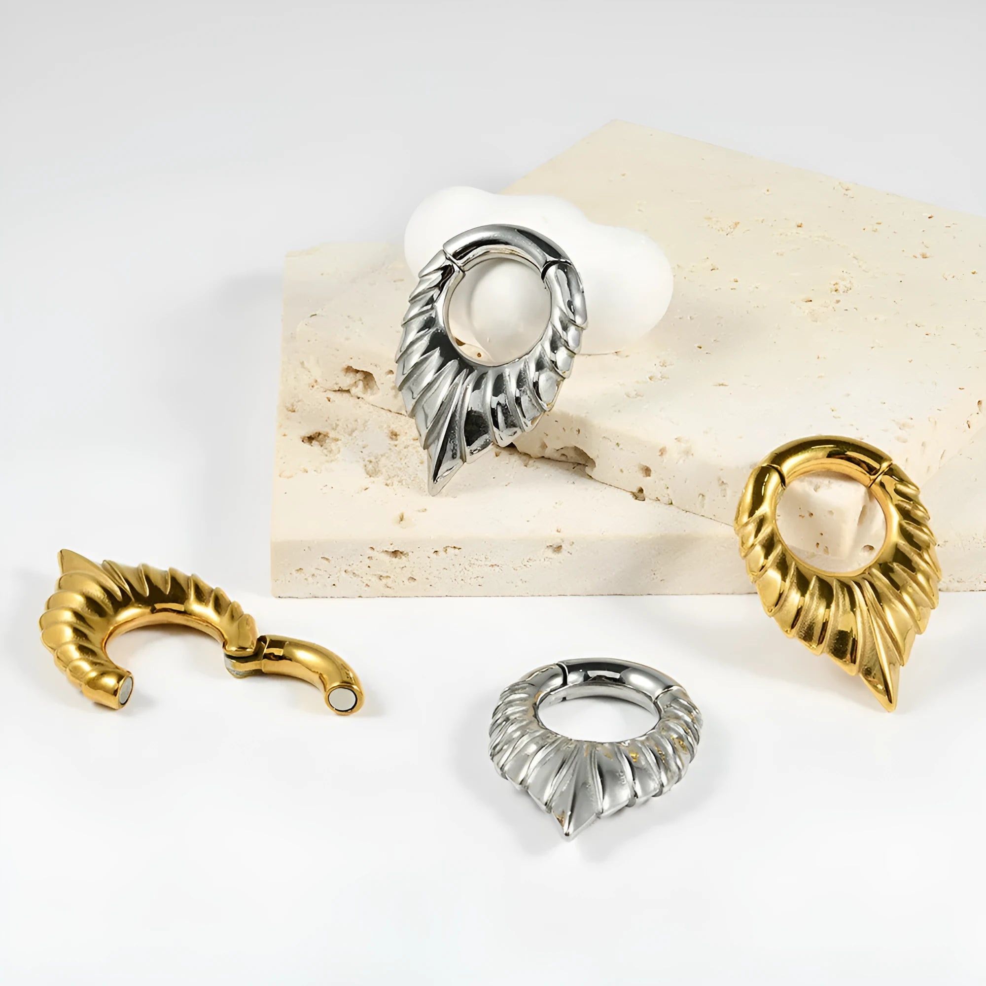Stainless steel drop-shaped ear extender with totem decoration for stretched earlobes.