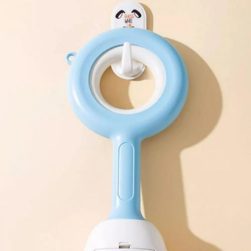 White blue and beige coloured cloud jaw design dog pooper scooper on a green lawn.
