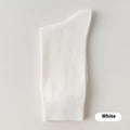 A pair of men's solid colour mid-calf socks made from combed cotton, shown in a light grey hue.