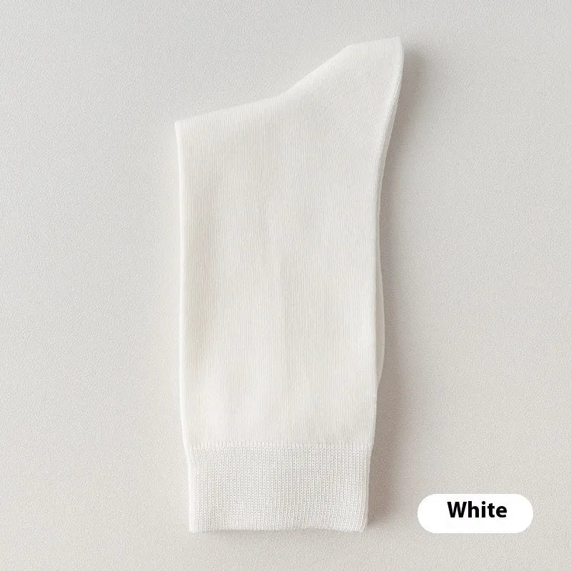 A pair of men's solid colour mid-calf socks made from combed cotton, shown in a light grey hue.