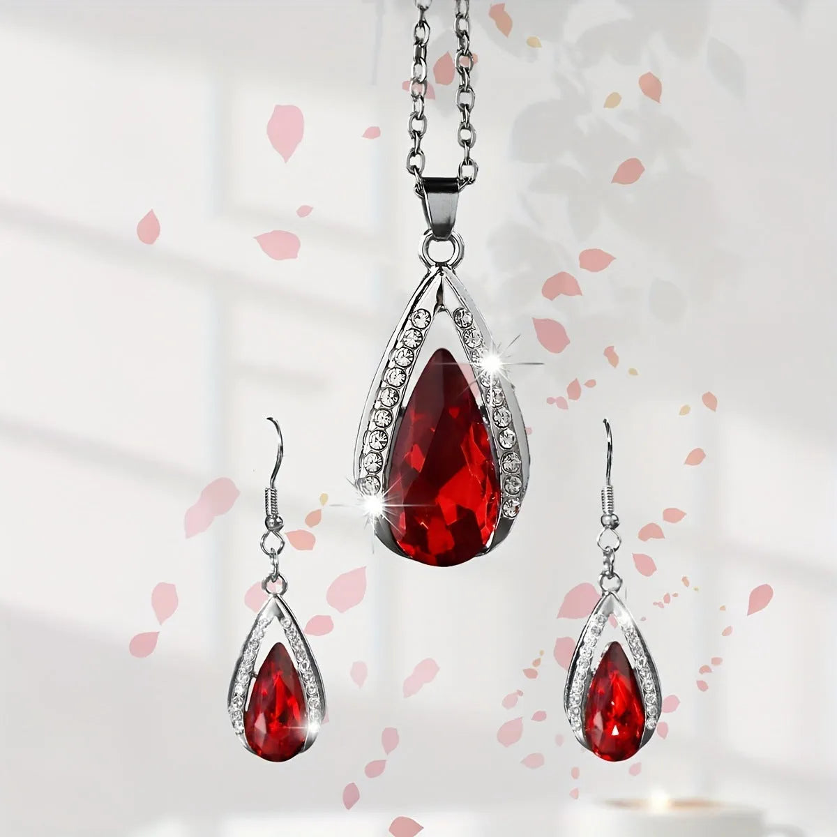 Black and red teardrop glass pendant necklace and matching earrings set on alloy chain.