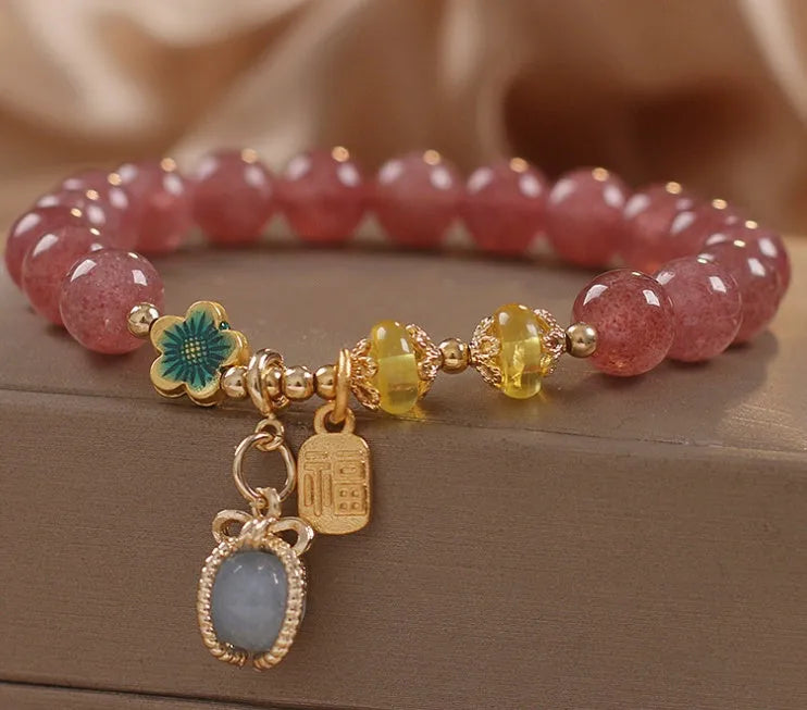 Red women's bracelet with natural strawberry quartz beads and rhinestone details on alloy setting