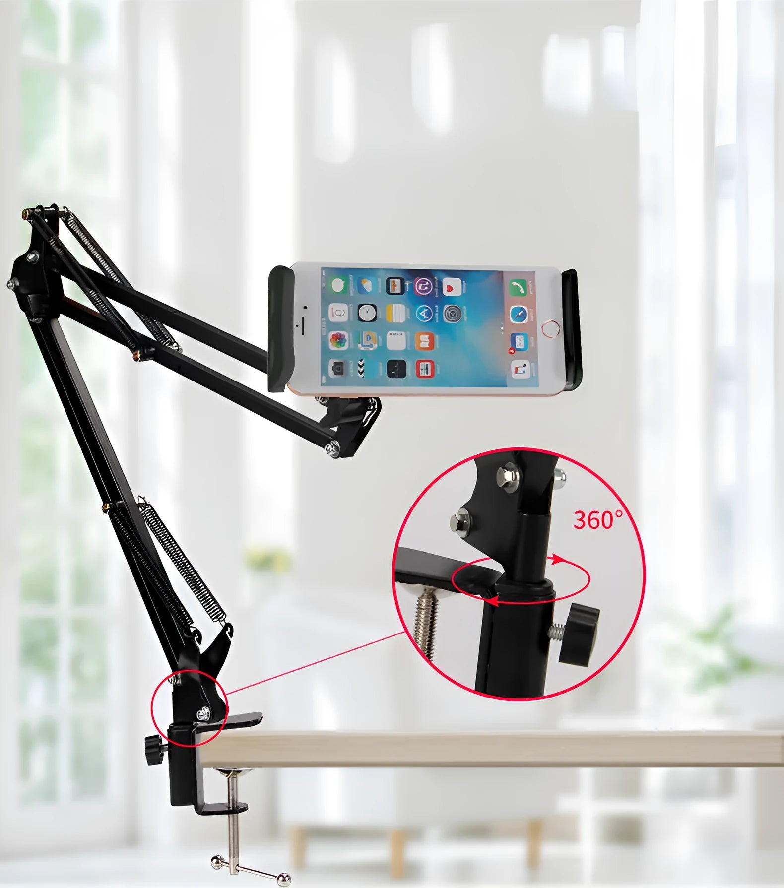 Black adjustable phone tablet stand with 360-degree rotation on wooden table