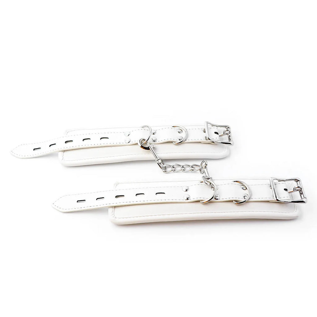 White PU sponge bondage set showing handcuffs, ankle cuffs, and a neck scarf.