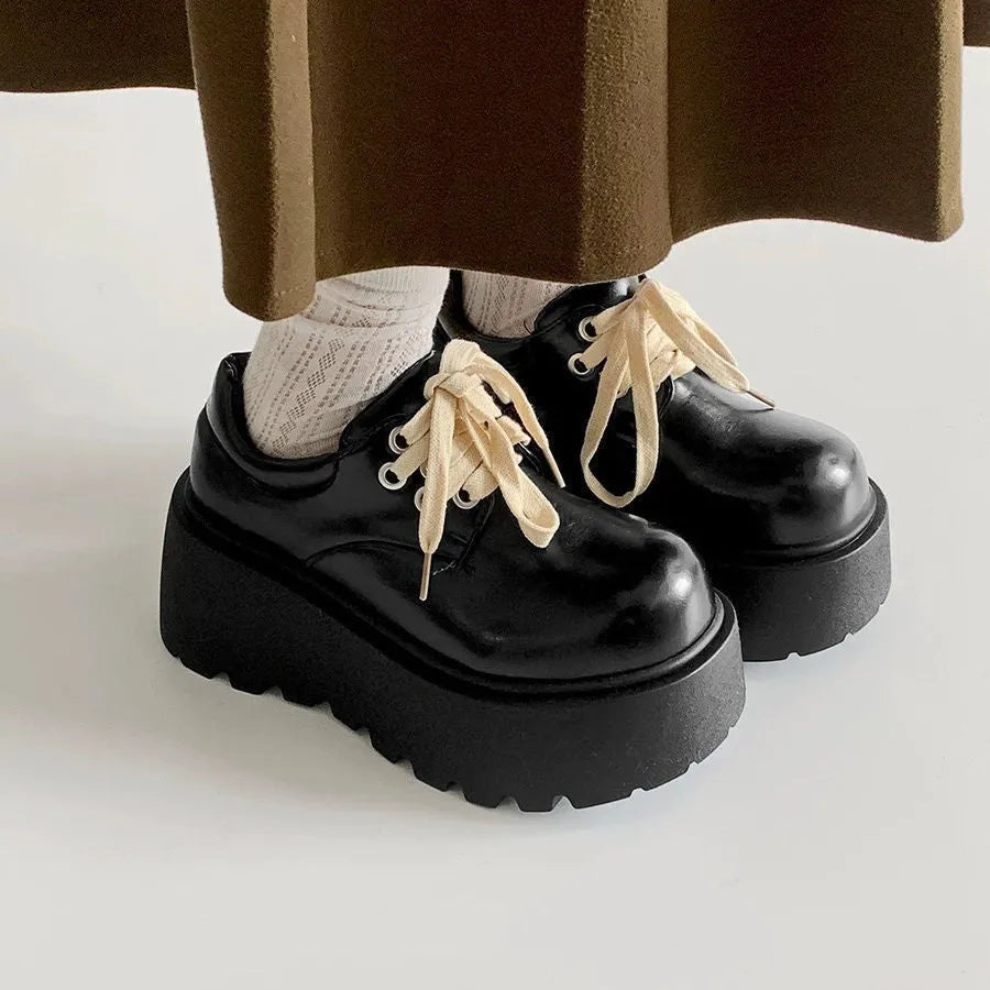 Matte black women's lace-up ankle boots with a chunky heel and thick sole.