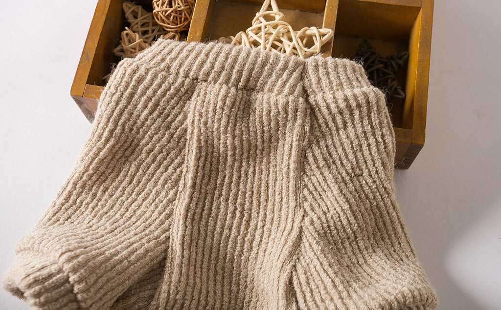 Brown knitted dog sweater pullover on small dog showing cloth construction and casual style