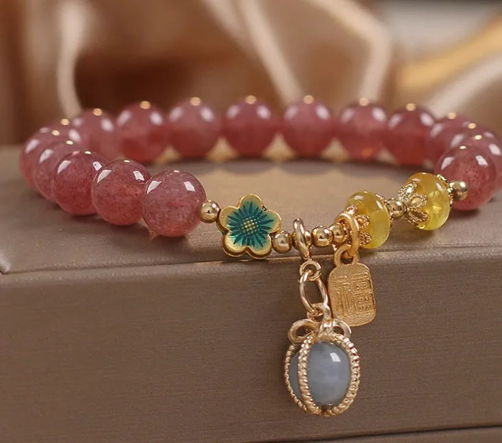 Red women's bracelet with natural strawberry quartz beads and rhinestone details on alloy setting