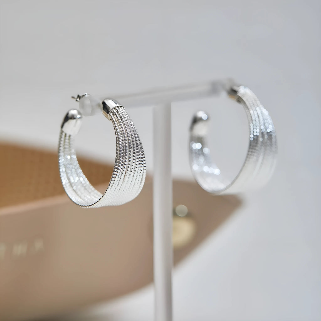 Geometric copper earrings with electroplated silver and gold finishes including stud and clip styles
