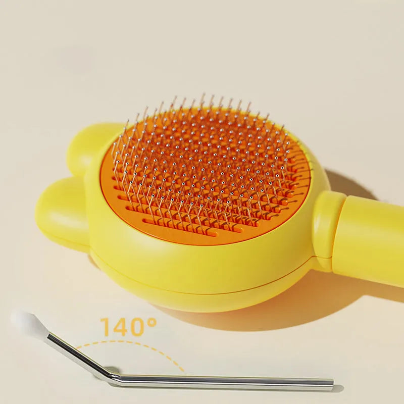 Green pet grooming brush with a release button and stainless steel teeth on a non-slip handle.